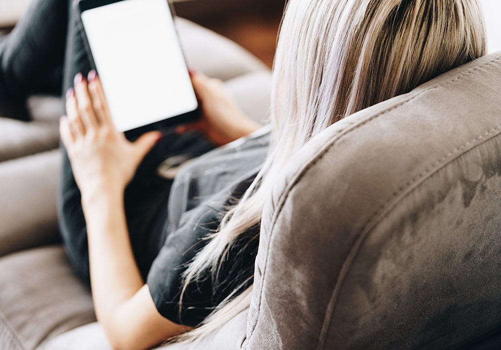 young-woman-reading-ebooks-on-her-pocket-reader-picjumbo-com