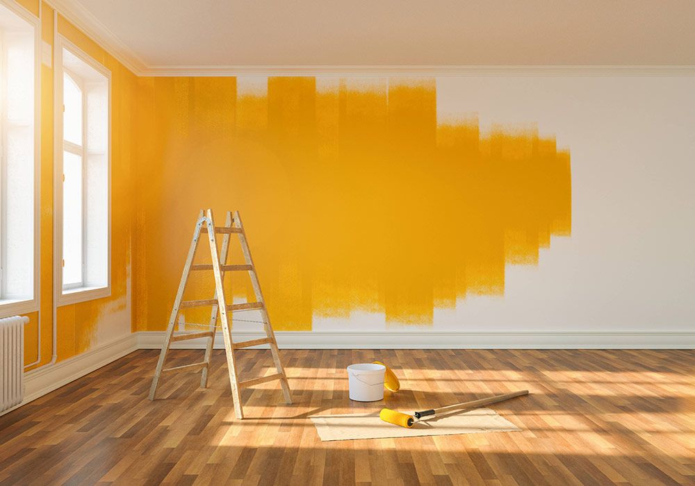 painting-wall-yellow-room-apartment-after-relocation-with-ladder-paint-bucket