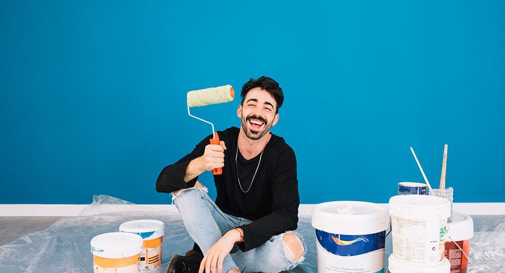 smiling-man-showing-paint-roll