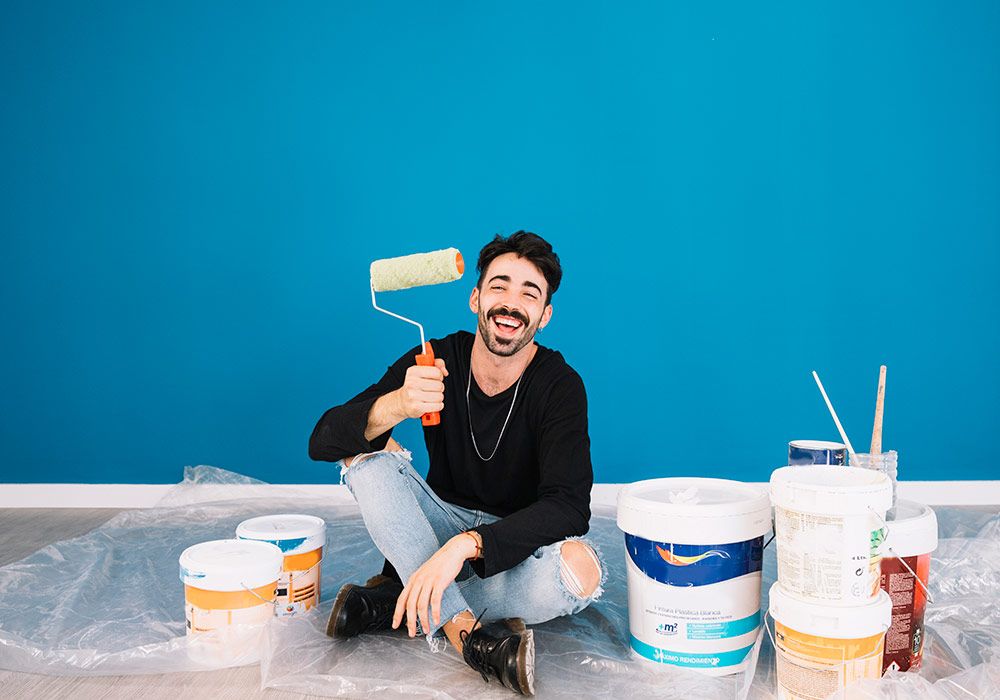 smiling-man-showing-paint-roll