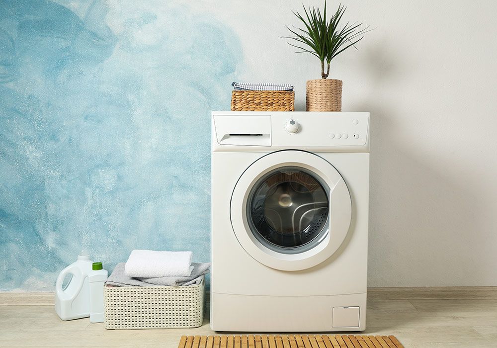 laundry-room-with-washing-machine-against-light-blue-wall-space-text