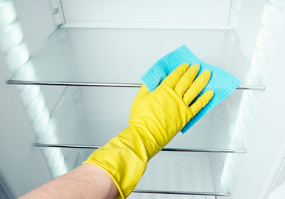 man-s-hand-washing-refrigerator-inside