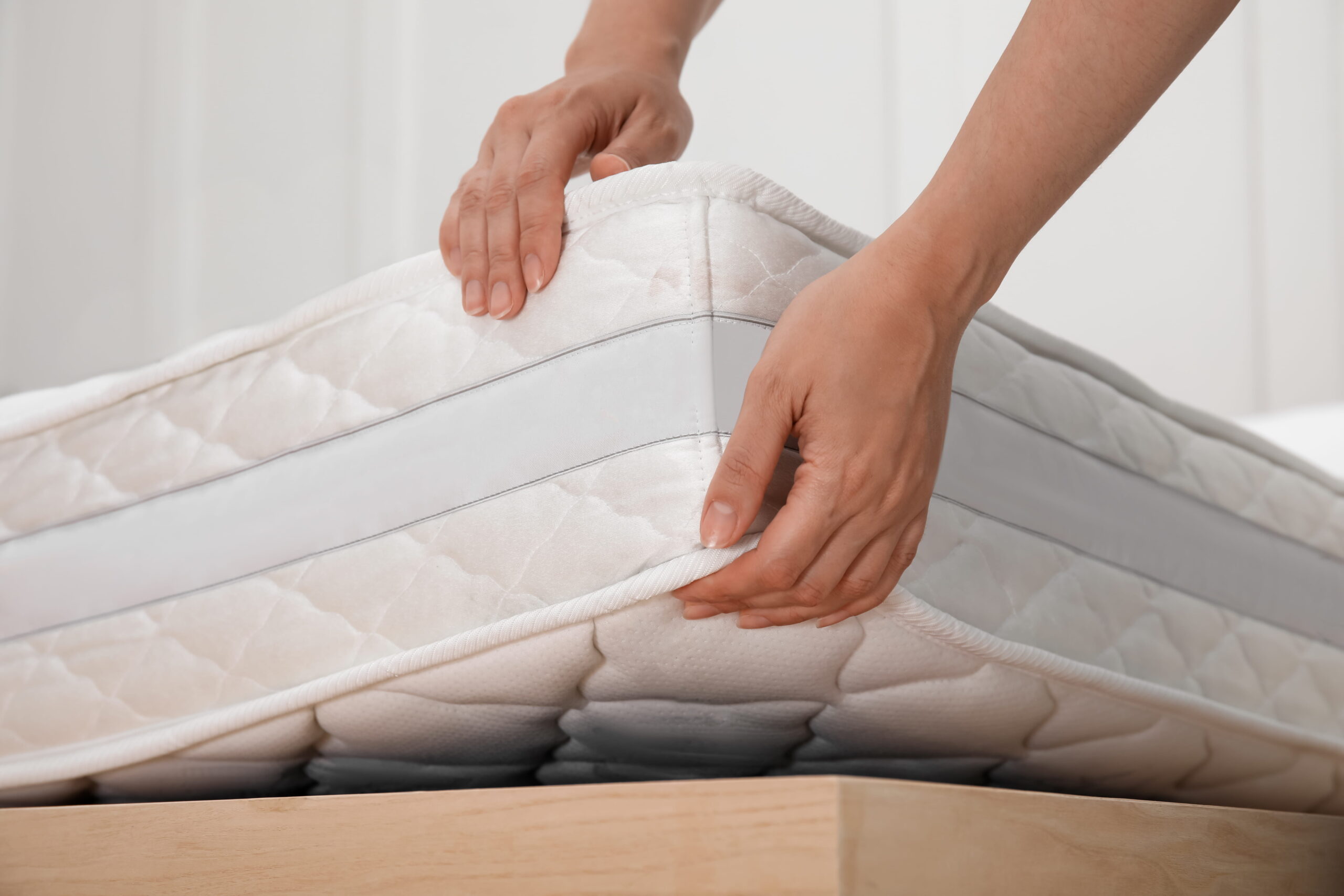 woman-putting-soft-white-mattress-bed-indoors-closeup (1)